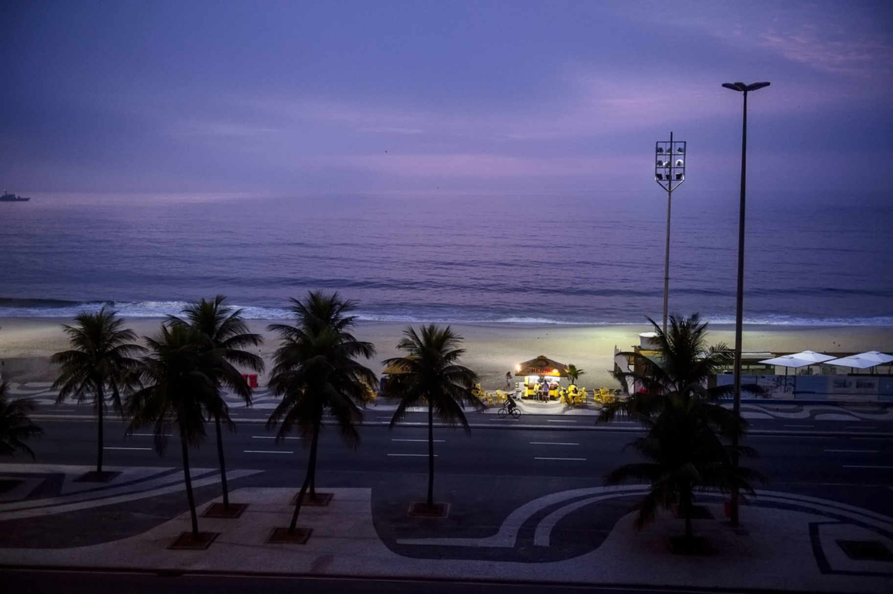 Copacabana street and beach scene at dusk. Rio de Janeiro. Brazil. 2011. © David Alan Harvey Magnum Photos